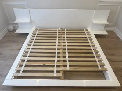 This is a CB2 Andes platform bed in high-gloss white lacquer (no longer produced), featuring integra...