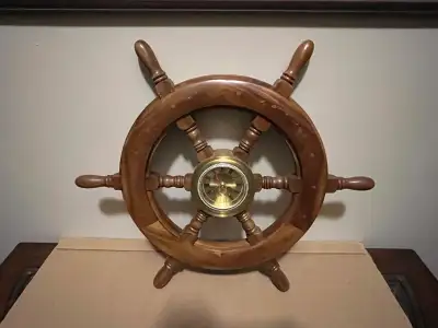 Ahoy there! Feast your eyes on this charming nautical ship wheel clock! A great piece to give your h...