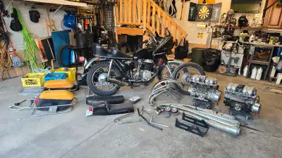 For sale is a Honda CB750, a vintage motorcycle from 1976, complete with a plethora of parts, includ...
