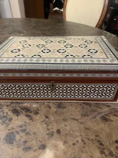 This beautifully crafted jewelry box, originating from Egypt, is a unique find. It features intricat...