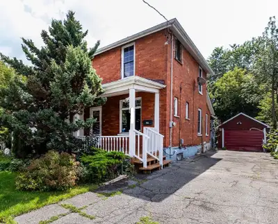 Spacious home featuring dark hardwood flooring throughout the main living areas. Kitchen includes wh...