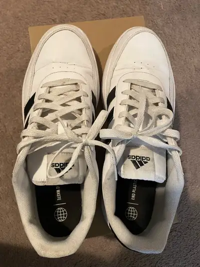 Classic Adidas sneakers with three black stripes. White leather upper with a rubber sole. Comfortabl...