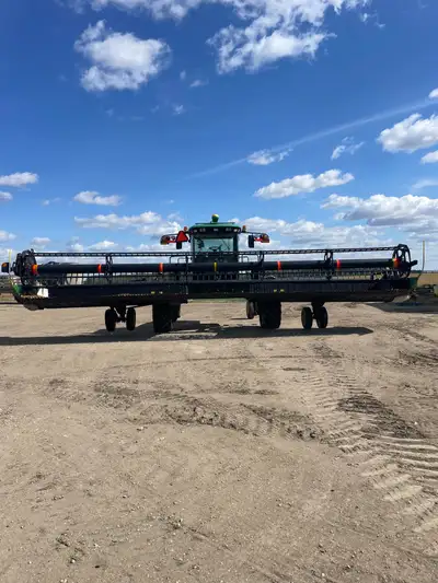 Low hr Jd 150 35 ft swather. Comes with Jd ATU, weight box and pull behind swath roller. Shedded. Ha...
