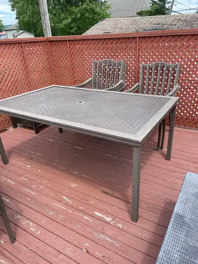 Glass top patio set with 6 chairs. Table 40 x 66 with textured glass top. 6 chairs with cushions inc...
