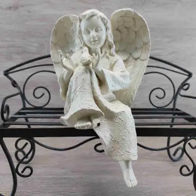 Sitting cherub winged angel with bird on knee. Selling for $40. Made from resin (non-concrete). Crea...