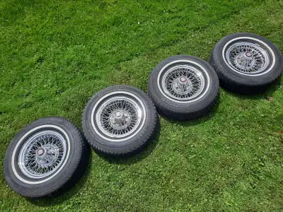 Factory Cadillac Brougham wire rims with white wall 225/75R15 tires. These are driver quality rims t...