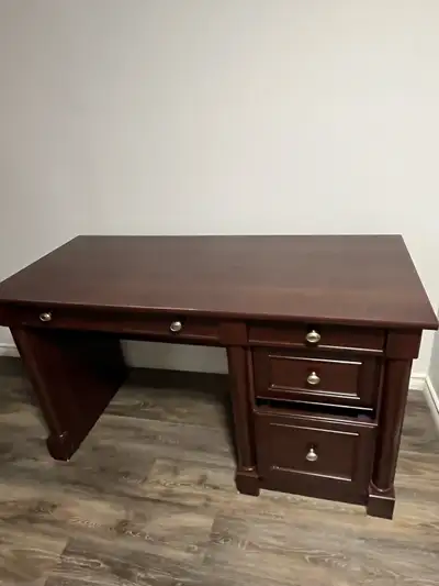 This is a sturdy and stylish cherry wood desk, perfect for a home office or study space. It features...