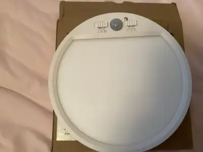 Illuminate your space with this used LED ceiling light, featuring a motion sensor for added convenie...