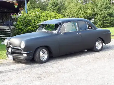 1950 Ford custom deluxe 2-door sedan with a 1949 flat head V8. Converted to 12v. Seats from a Pontia...