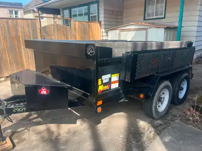 Used only 1 year, down for 2 years. Dump trailer with remote, ramps with wheel barrow access, and ex...