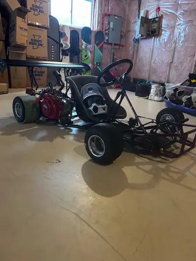 Custom go-kart with a strong Honda GX160 5.5 engine. It has a cool purple frame and racing slick tir...