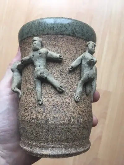 This is a vintage heavy ceramic mug/cup with small nude figures dancing around it, both men and wome...