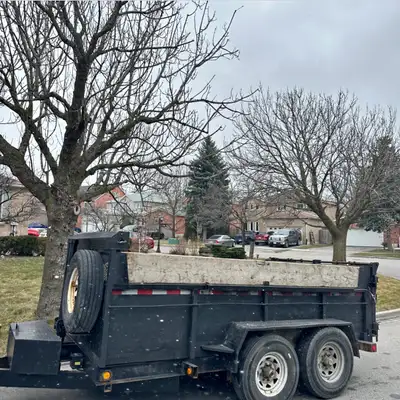 This is a heavy-duty utility trailer perfect for dumping and hauling various materials, sized in the...