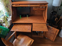 Rolltop desk and antique bankers chair. Solid oak.