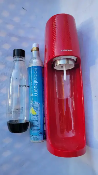 SodaStream sparkling water maker in excellent working condition. It comes with the main red unit, on...