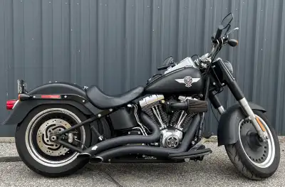 I'm selling my 2011 Harley-Davidson Fat Boy Lo, a stylish cruiser with Vance & Hines pipes and a K&N...