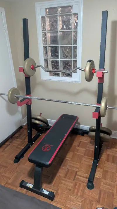 Get ready to pump some iron with this used workout equipment! This set includes a sturdy bench press...