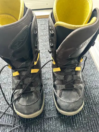 Black GNU snowboard boots with traditional laces. This pair has a yellow inner lining and yellow lac...