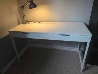 This white IKEA MICKE desk features a clean design with built-in cable management and two convenient...