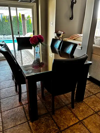 Dining room table set with 8 brown leather chairs., View more