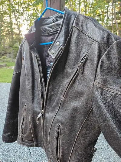 This is a Dream Apparel motorcycle leather jacket, size 44. A sturdy and stylish piece for any rider...