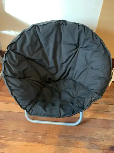 This is a used black papasan chair with a sturdy metal frame, perfect for adding a cozy spot to any...