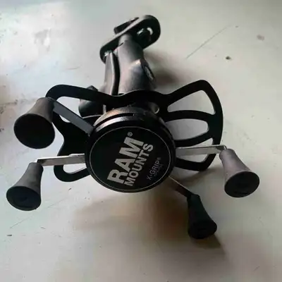I'm selling a used RAM X-Grip handlebar mount, perfect for securely holding your device on your moto...
