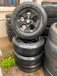 Used Bridgestone Dueler A/T tires on Black Jeep Rims