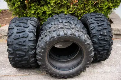 Tires have had moderate use with no visible cracking or damage. 26x9x14 from 7" rims on the front en...