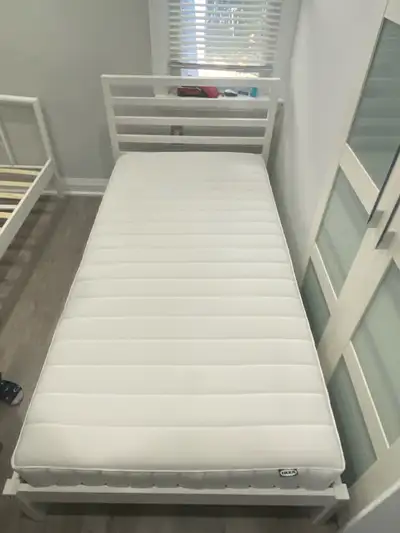 Description: Selling a sturdy and stylish white wooden twin bed frame with a comfortable IKEA foam m...