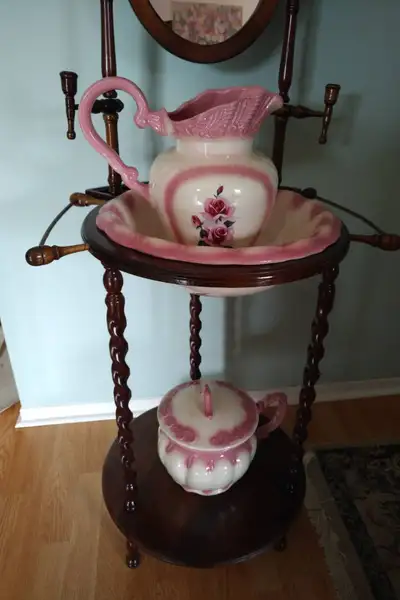 Beautiful polished dark wood antique look wash stand, with side towel racks and candlestick holders....
