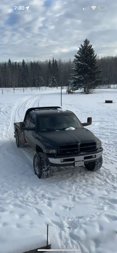 Bone stock 1998.5 ram 2500 24valve 5 speed manual 268,xxx km 5” mbrp straight pipe skirted cm deck w...