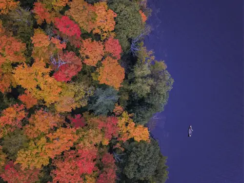 Mid-century modern waterfront cottage in the heart of Gatineau Hills, Chelsea, Quebec, surrounded by...