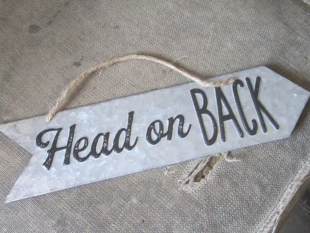 DECORATIVE ARROW HEAD ON BACK TIN SIGN $15.00 CABIN DECOR