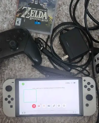 Nintendo switch oled in excellent condition with memory card, pro controller and game.