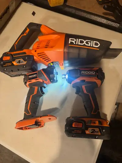 I'm offering a set of used Ridgid tools, including a cordless vacuum, an impact driver, and a flashl...