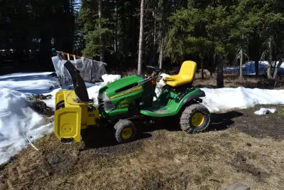 John Deere LA 145 lawn tractor. Comes with, mower deck, snow blower, counter weights, tire chains. S...