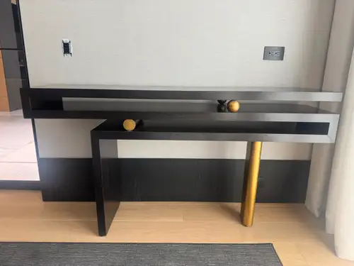 Custom console featuring a sculptural geometric design in Macassar wood with gold leaf accents. Mate...