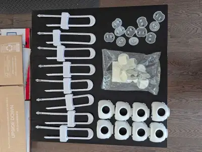 Selling a mixed lot of baby safety devices. Includes multiple cabinet locks, door knob covers, table...