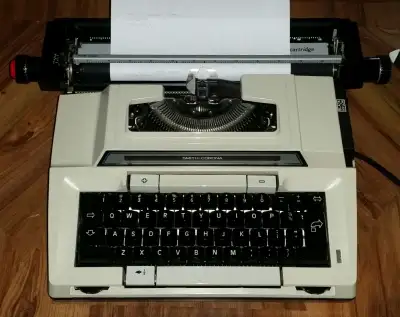 Smith Corona electric typewriter, with original case, cartridges, View more