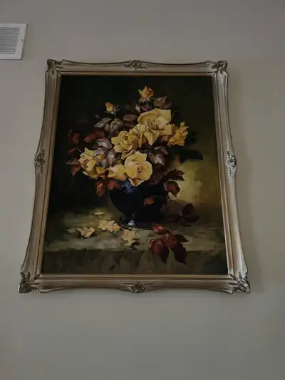 This is a framed, vintage-style oil painting of a floral still life featuring yellow roses. It is an...