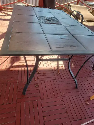 Metal patio table with removable ceramic Very sturdy and never wobbly Can change the ceramic to your...