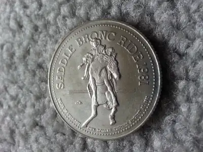 1981 CALGARY STAMPEDE COLLECTOR DOLLAR. Salute to the Saddle Bronc Rider's and the early pioneer of...