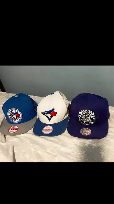 Get your hands on these rare vintage retro Blue Jays and Raptors snapback hats. These hats are in gr...