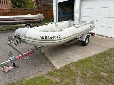 Zodiac 10.5 inflatable aluminum floor boat. Comes with a brand new boat trailer. Electric pump, benc...