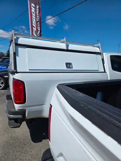 Construction cap for Chev Silverado 6.5 foot box. Opening storage side panels both sides. A fraction...