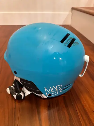 Stay safe on the slopes with this bright blue Marker ski and snowboard helmet, designed to keep you...