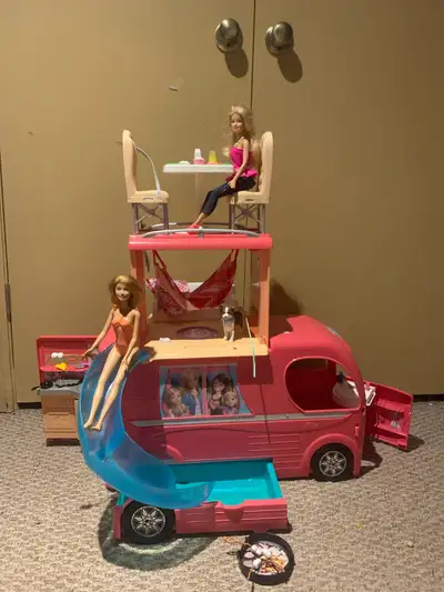 The Barbie camper comes with a lot of different parts, and two dolls, and a dog! This used Barbie ca...