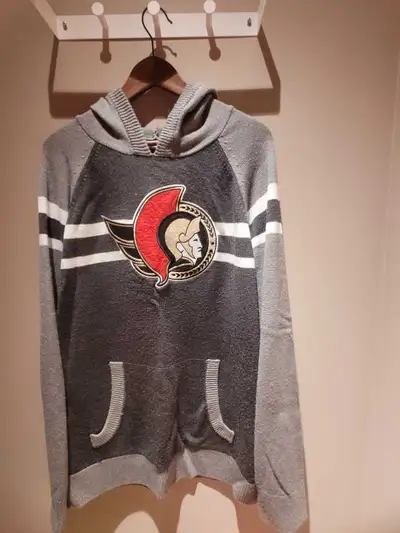 This Ottawa Senators knitted hoodie is perfect for any fan! It's in good used condition. This hoodie...