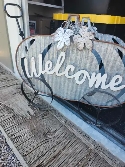 Add a touch of rustic charm to your home with this used metal pumpkin welcome planter! It features a...